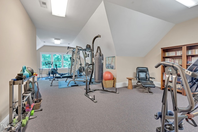 workout area with vaulted ceiling, baseboards, and carpet floors