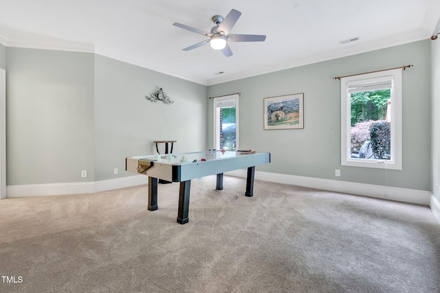 game room with crown molding, plenty of natural light, a ceiling fan, and carpet flooring