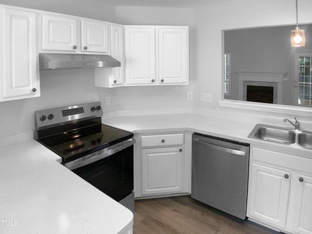 2747 Michelle Ct, Creedmoor, NC 27522 - kitchen featuring appliances with stainless steel finishes, under cabinet range hood, a sink, light countertops, and white cabinets