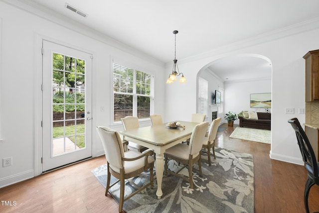 1720 Laurel Park Pl, Cary, NC 27511 - dining room with arched walkways, ornamental molding, wood finished floors, and baseboards