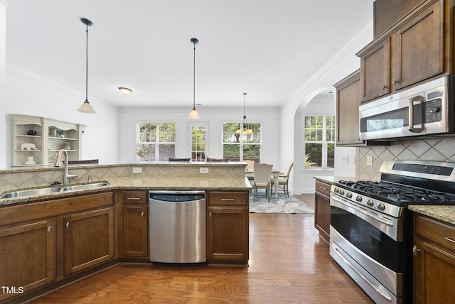 1720 Laurel Park Pl, Cary, NC 27511 - kitchen with stainless steel appliances, a sink, tasteful backsplash, ornamental molding, and dark wood-style floors