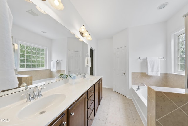 1720 Laurel Park Pl, Cary, NC 27511 - bathroom featuring a garden tub, double vanity, tile patterned flooring, and baseboards
