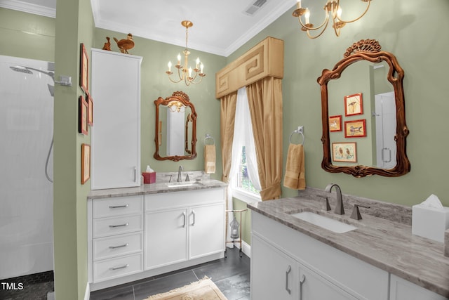 bathroom with a chandelier, ornamental molding, two vanities, and a tile shower