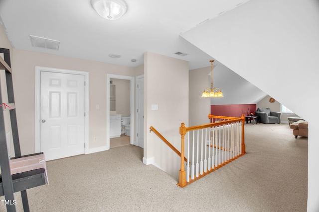 corridor with carpet floors, an upstairs landing, and baseboards