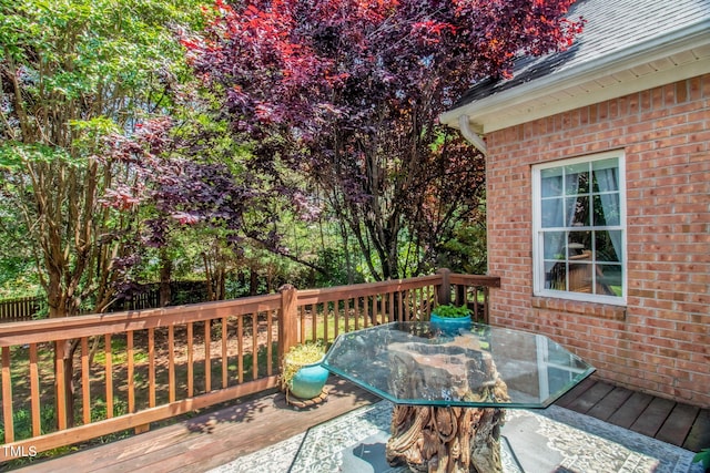 wooden deck featuring outdoor dining space and fence