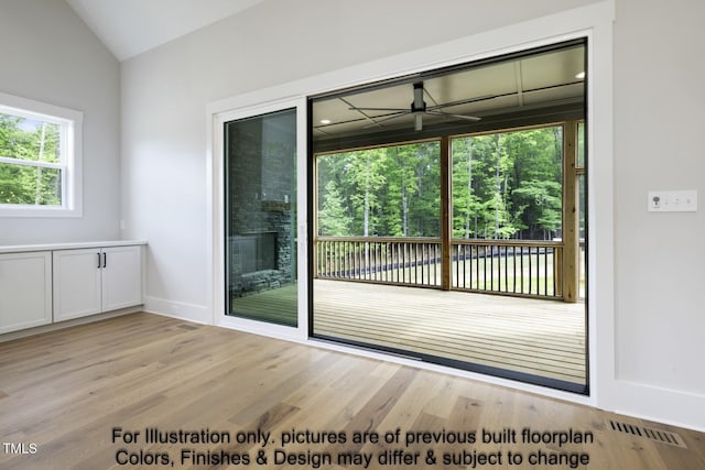 entryway with light wood-type flooring, lofted ceiling, ceiling fan, and baseboards