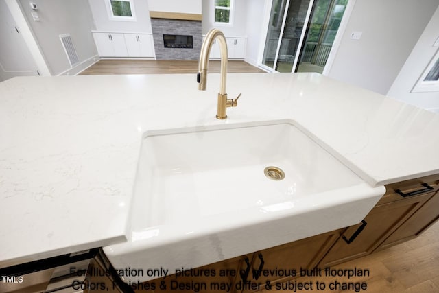 detailed view of a sink and a glass covered fireplace