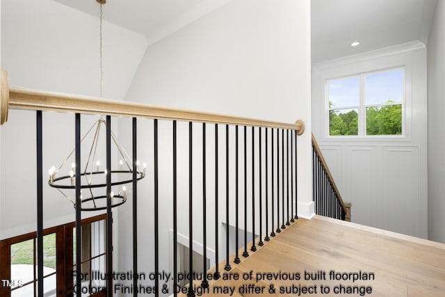 staircase featuring a chandelier and wood finished floors
