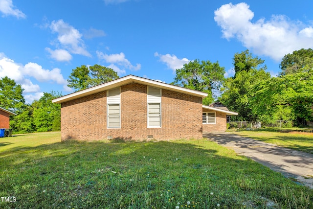 5830 Mcdougal Dr, Fayetteville, NC 28304 - view of home's exterior with crawl space, a yard, and brick siding