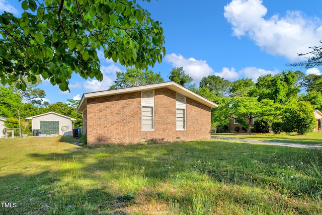 5830 Mcdougal Dr, Fayetteville, NC 28304 - view of side of home with brick siding, crawl space, a detached garage, a lawn, and cooling unit