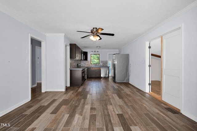5830 Mcdougal Dr, Fayetteville, NC 28304 - kitchen with appliances with stainless steel finishes, dark wood-type flooring, ornamental molding, ceiling fan, and tasteful backsplash