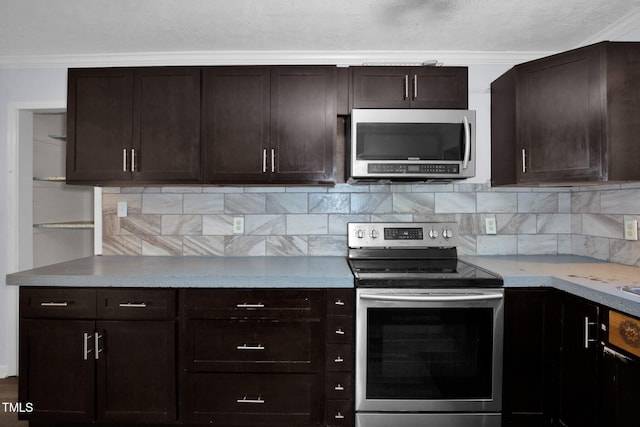 5830 Mcdougal Dr, Fayetteville, NC 28304 - kitchen featuring stainless steel appliances, tasteful backsplash, dark brown cabinetry, light countertops, and ornamental molding