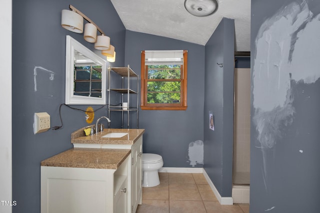 5830 Mcdougal Dr, Fayetteville, NC 28304 - bathroom with tile patterned floors, vaulted ceiling, toilet, vanity, and a shower