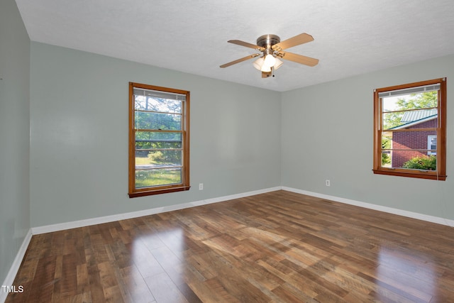 5830 Mcdougal Dr, Fayetteville, NC 28304 - unfurnished room featuring healthy amount of natural light, a ceiling fan, wood finished floors, and baseboards