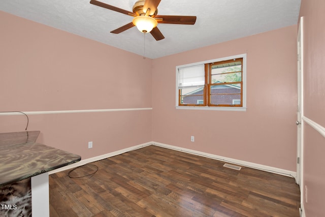 5830 Mcdougal Dr, Fayetteville, NC 28304 - unfurnished room with dark wood-style flooring, a ceiling fan, and baseboards