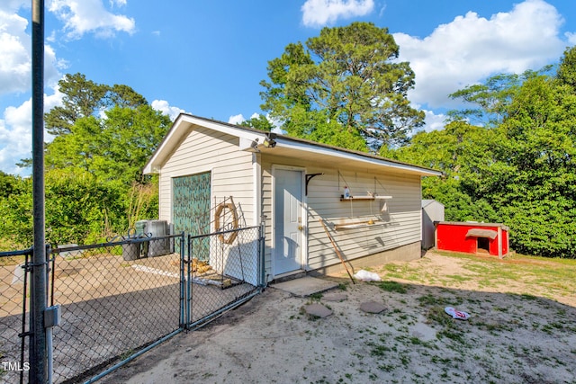 5830 Mcdougal Dr, Fayetteville, NC 28304 - view of outbuilding featuring a gate, fence, and an outbuilding