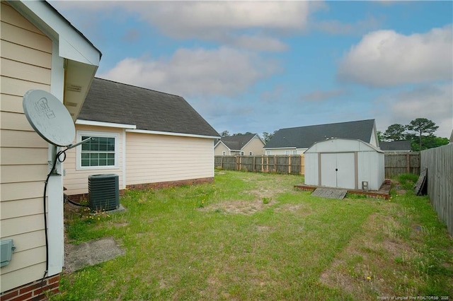 view of yard featuring cooling unit, a storage shed, and an outdoor structure