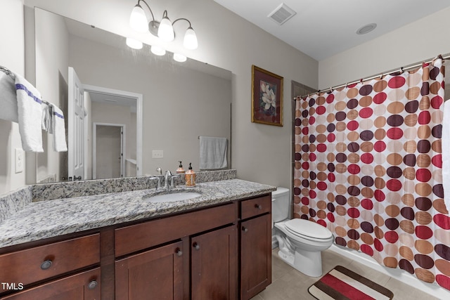 bathroom with toilet, vanity, tile patterned flooring, and curtained shower