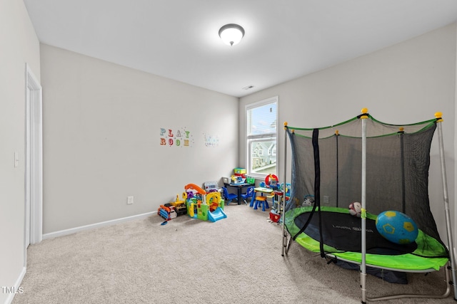 rec room featuring carpet floors and baseboards