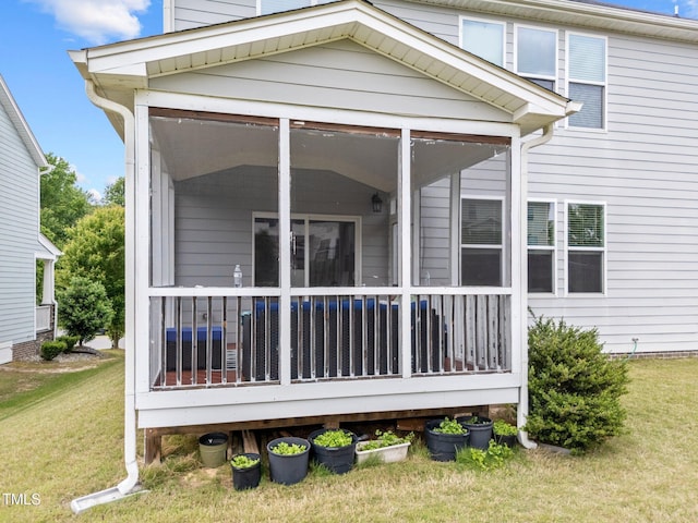 back of house featuring a sunroom and a yard