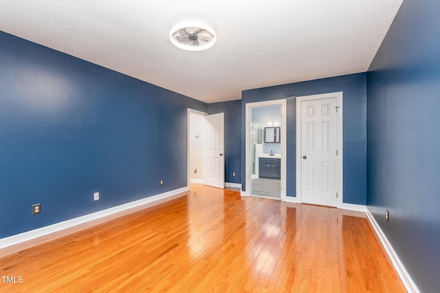 105 Houston Cir, Cary, NC 27513 - unfurnished bedroom featuring light wood-type flooring, baseboards, and ensuite bathroom