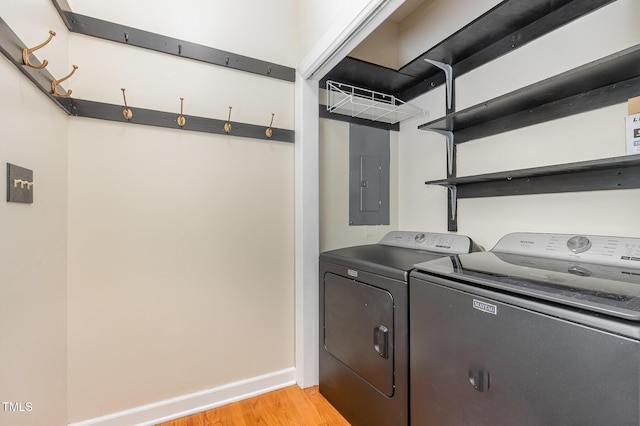 105 Houston Cir, Cary, NC 27513 - laundry room featuring washer and dryer, light wood-style flooring, baseboards, and electric panel
