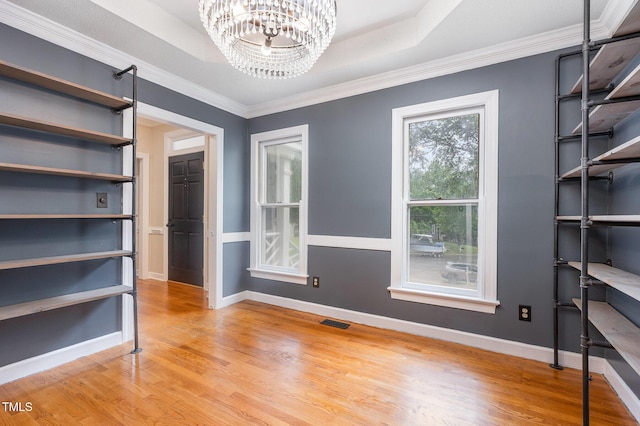 105 Houston Cir, Cary, NC 27513 - unfurnished bedroom with light wood-type flooring, a chandelier, baseboards, ornamental molding, and a raised ceiling