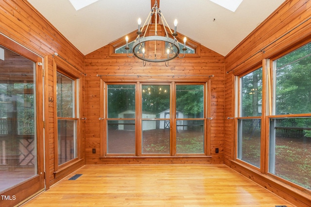 105 Houston Cir, Cary, NC 27513 - unfurnished sunroom with a skylight, vaulted ceiling, wood walls, wood finished floors, and a chandelier