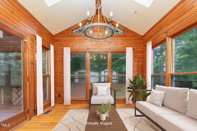 105 Houston Cir, Cary, NC 27513 - sunroom with lofted ceiling, a skylight, wooden walls, a chandelier, and wood finished floors