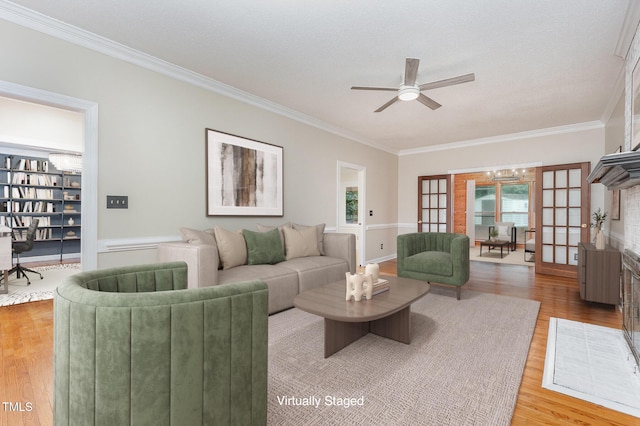 105 Houston Cir, Cary, NC 27513 - living room with crown molding, wood finished floors, ceiling fan, and a chandelier