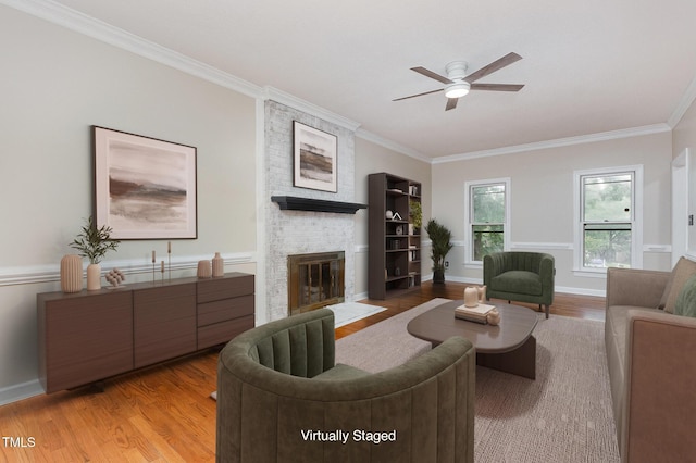 105 Houston Cir, Cary, NC 27513 - living area with a fireplace, light wood finished floors, crown molding, ceiling fan, and baseboards