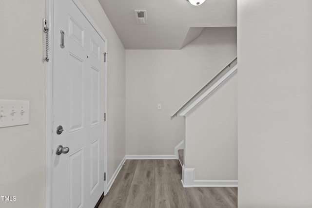 entryway with light wood-type flooring and baseboards