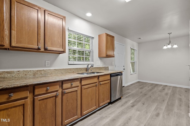 kitchen with stainless steel dishwasher, a sink, brown cabinets, a chandelier, and recessed lighting