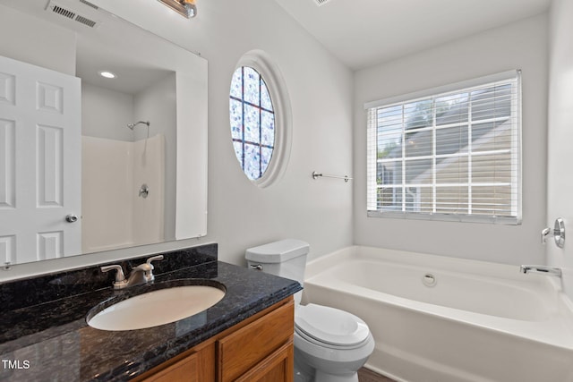 full bathroom featuring healthy amount of natural light, toilet, a tub, and vanity