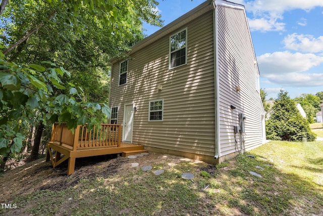 rear view of house featuring a wooden deck