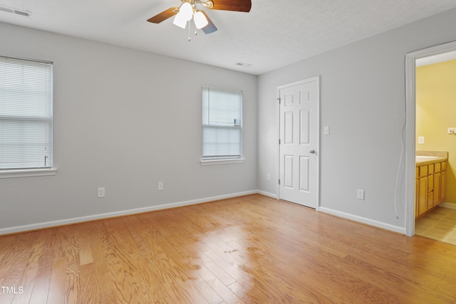 3108 Forrestal Dr, Durham, NC 27703 - unfurnished bedroom featuring multiple windows, light wood finished floors, and ensuite bathroom