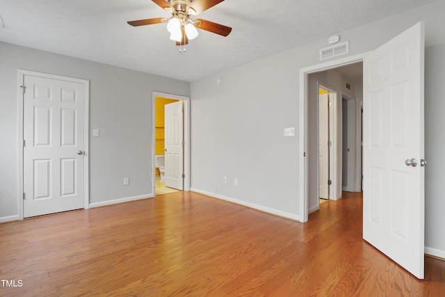 3108 Forrestal Dr, Durham, NC 27703 - unfurnished bedroom with light wood-type flooring, baseboards, connected bathroom, and a ceiling fan