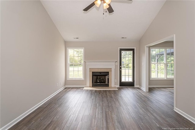 551 Hobson Rd, Raeford, NC 28376 - unfurnished living room with lofted ceiling, dark wood-style flooring, baseboards, a ceiling fan, and a fireplace with raised hearth