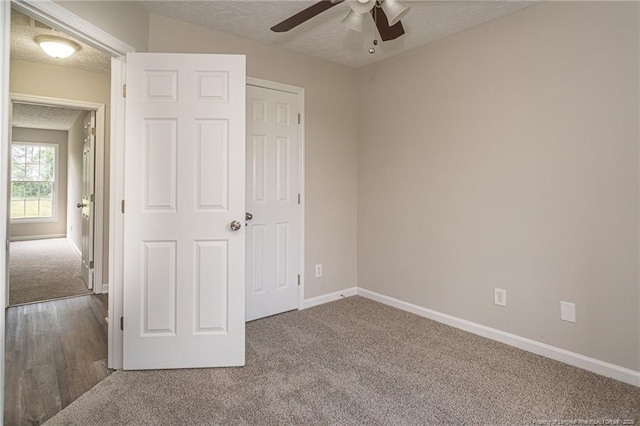 551 Hobson Rd, Raeford, NC 28376 - unfurnished bedroom featuring carpet floors, a textured ceiling, baseboards, and ceiling fan