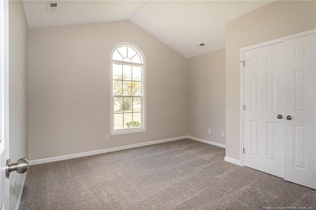 551 Hobson Rd, Raeford, NC 28376 - carpeted empty room featuring vaulted ceiling, plenty of natural light, and baseboards
