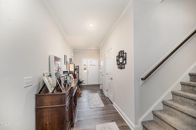 entrance foyer featuring ornamental molding, stairs, dark wood-style flooring, recessed lighting, and baseboards