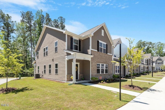 1440 Latham Garden Dr, Wake Forest, NC 27587 - view of front of property with a front yard, brick siding, and central air condition unit