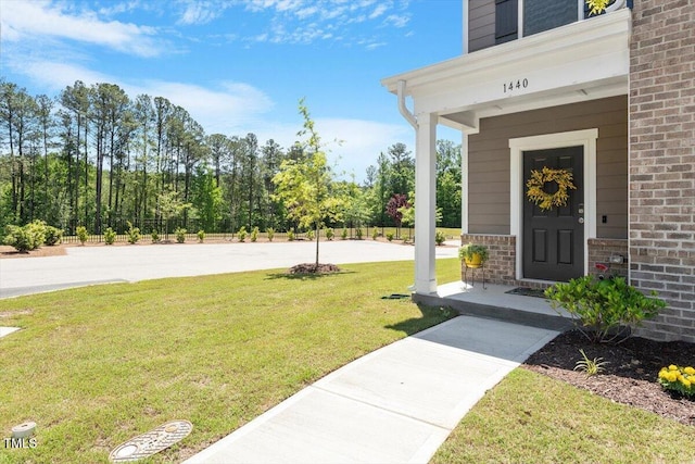1440 Latham Garden Dr, Wake Forest, NC 27587 - entrance to property featuring brick siding and a lawn