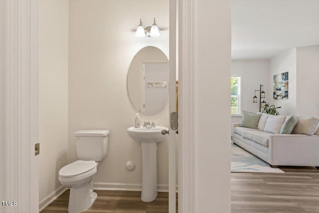 1440 Latham Garden Dr, Wake Forest, NC 27587 - bathroom with wood finished floors, toilet, baseboards, and a sink