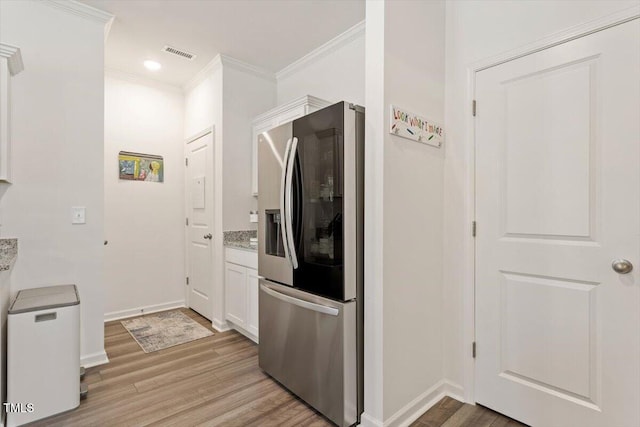 1440 Latham Garden Dr, Wake Forest, NC 27587 - kitchen featuring stainless steel fridge, light wood-type flooring, ornamental molding, white cabinets, and baseboards