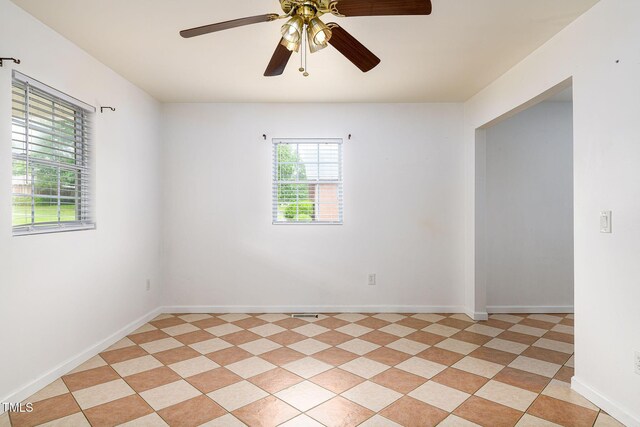 1309 Jackson St, Burlington, NC 27217 - spare room featuring a ceiling fan and baseboards