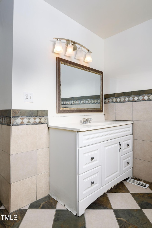 1309 Jackson St, Burlington, NC 27217 - bathroom featuring tile walls, wainscoting, vanity, and tile patterned flooring