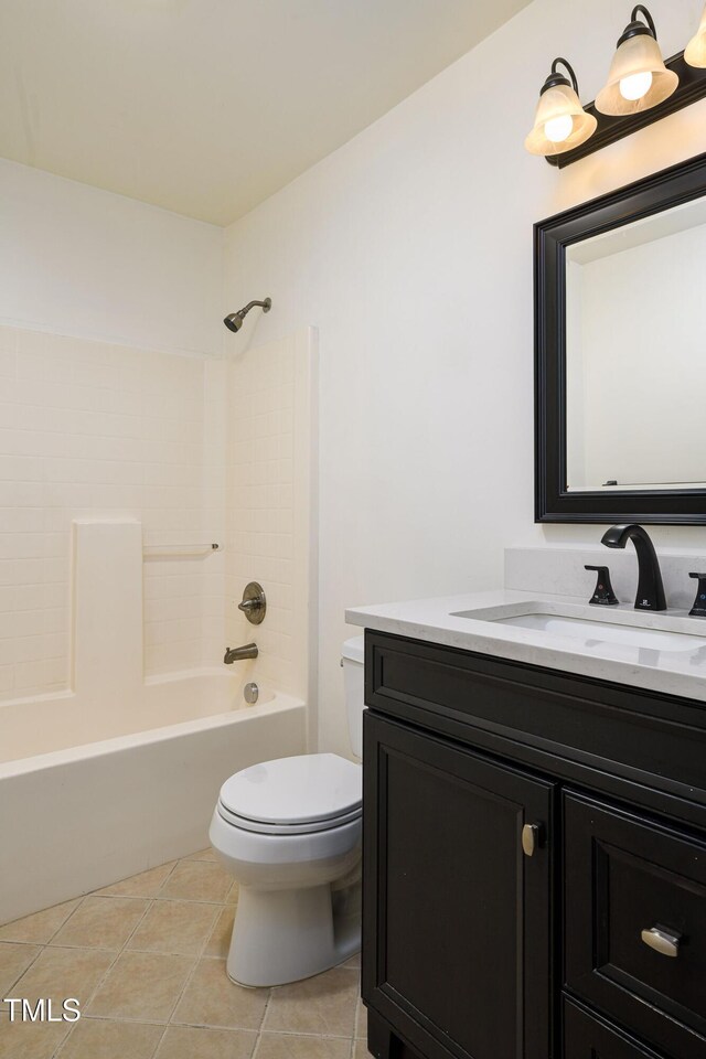 1309 Jackson St, Burlington, NC 27217 - bathroom with toilet, tile patterned flooring, vanity, and washtub / shower combination