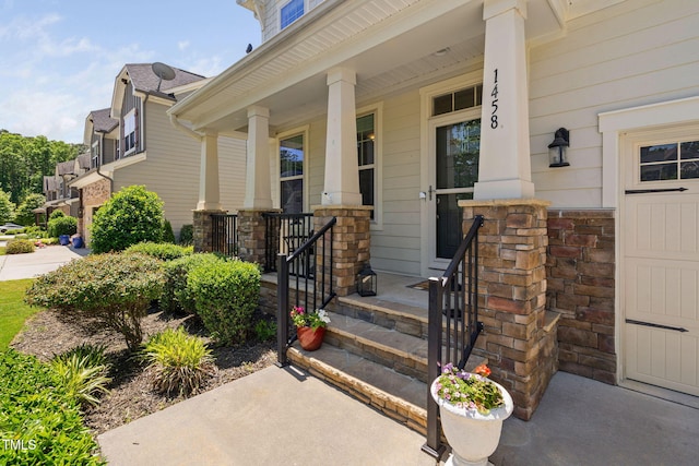 doorway to property with stone siding and a porch