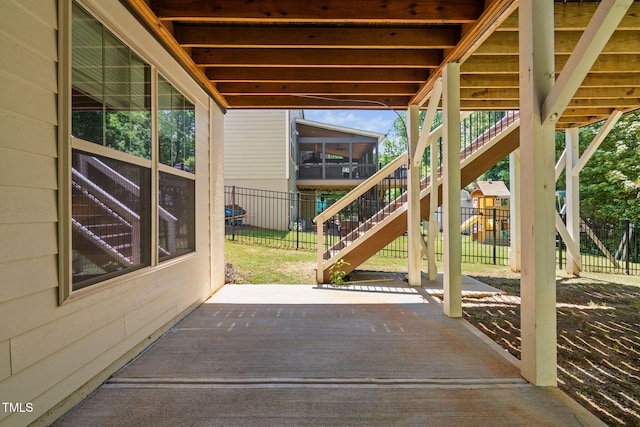view of patio / terrace featuring stairs and fence